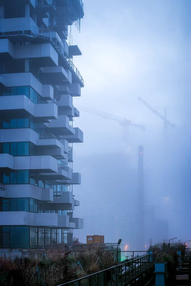 Stacked balcony tower (Trudo Toren) disappearing into blue morning fog