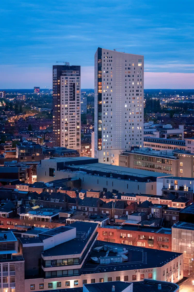 City rooftops and two tall towers (Regent & Admirant) at blue hour from above
