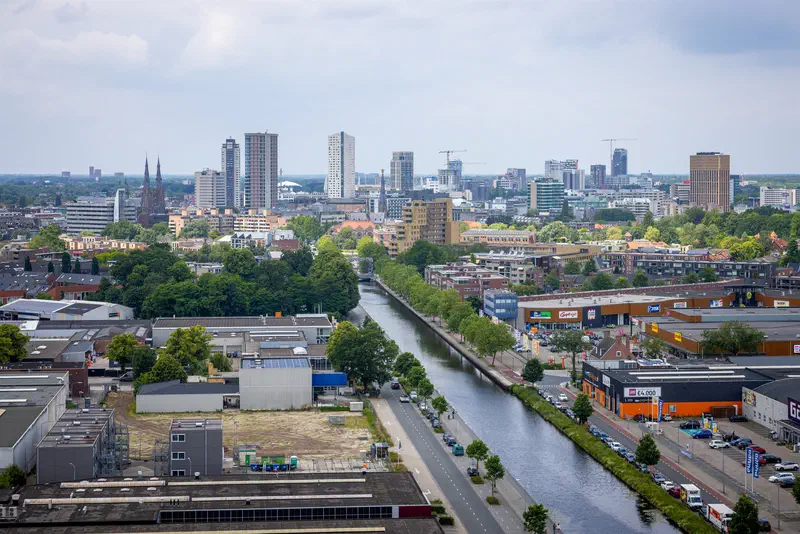 Canal running toward the Eindhoven city skyline seen from above