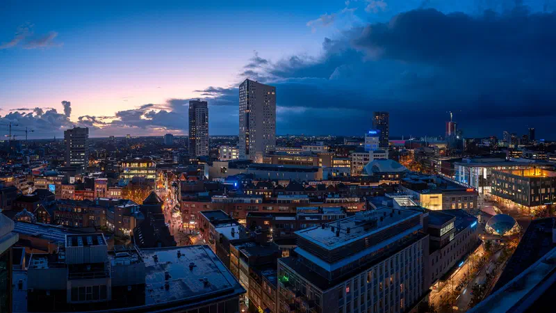 Eindhoven city skyline at dusk with dark storm clouds approaching