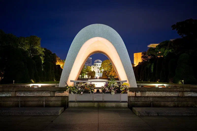 Hiroshima Peace Memorial arch framing the Atomic Bomb Dome at night