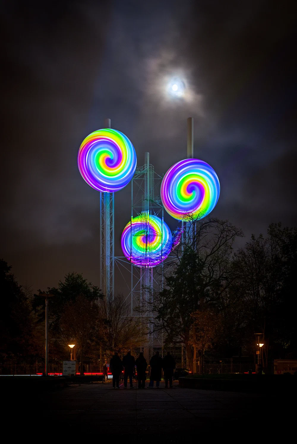 Candy-cane projection on a water tower during GLOW
